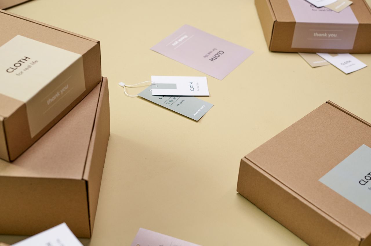 Mastering the First Impression: Your intriguing post title goes here Simple and minimalist cardboard packaging boxes with labels on a yellow surface.